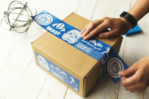 person packing blue and brown box